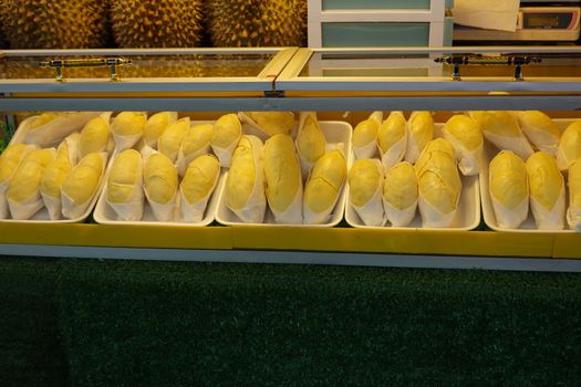 durian fruit in packages on sale in market, yellow durian in packaging as seasonal fruit of Thailand. 