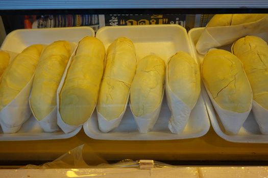 durian fruit in packages on sale in market, yellow durian in packaging as seasonal fruit of Thailand. 