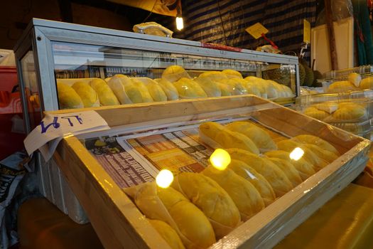 durian fruit in packages on sale in market, yellow durian in packaging as seasonal fruit of Thailand. 