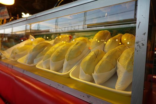 durian fruit in packages on sale in market, yellow durian in packaging as seasonal fruit of Thailand. 