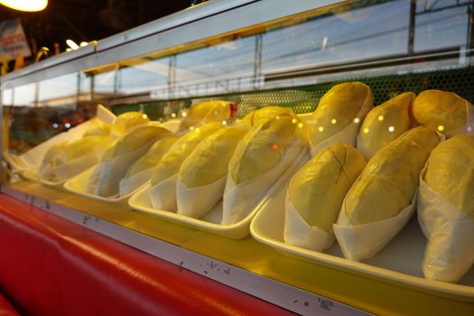 durian fruit in packages on sale in market, yellow durian in packaging as seasonal fruit of Thailand. 