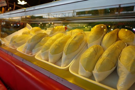 durian fruit in packages on sale in market, yellow durian in packaging as seasonal fruit of Thailand. 