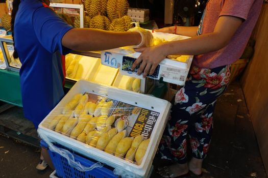 durian fruit in packages on sale in market, yellow durian in packaging as seasonal fruit of Thailand. 