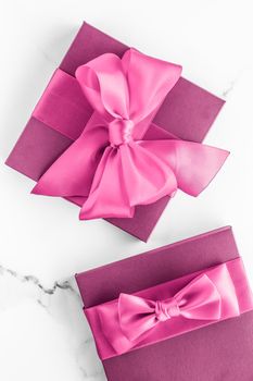 Birthday, wedding and girly branding concept - Pink gift box with silk bow on marble background, girl baby shower present and glamour fashion gift for luxury beauty brand, holiday flatlay art design