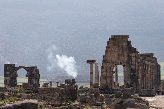 Volubilis is a site of Roman ruins and formerly a partly excavated Berber city in Morocco near the city of Meknes.The images show the ruined buildings and columns that are part of the large site High quality photo