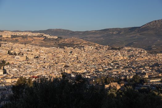 Fes Morocco cityscape with medina in centre seen from hills above in bright sun . High quality photo