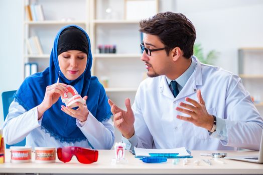 Dentist doctor and assistant working on new tooth implant