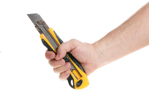 Hand holds a construction knife on a white background, a template for designers. Close up