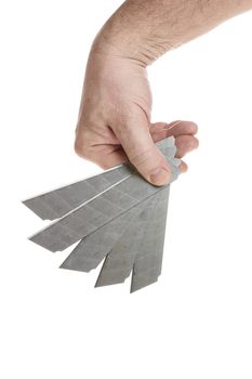 Hand holds a blade for a construction knife on a white background, a template for designers.