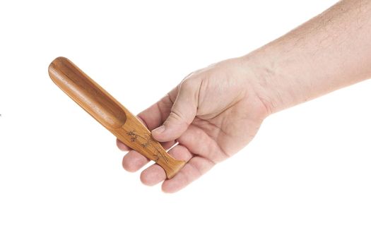 Hand holds a small wooden scoop for cereals on a white background, a template for designers.