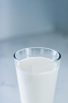 Dairy, healthy nutrition and breakfast concept - World Milk Day, full glass on marble table