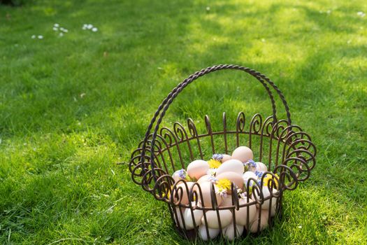 Basket with eggs on the grass to find on easter morning