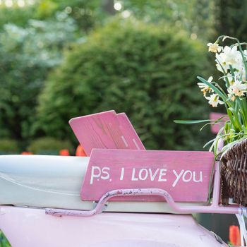 Pink sign on the seat of a scooter saying 'P.S. I love you'