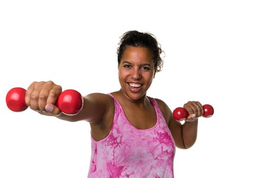 Mixed raced young woman  in pink shirt exercising with red 2 kg weights dumbbells isolated in white