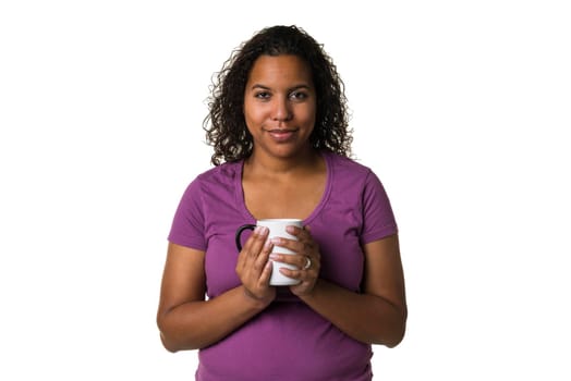 Young mixed race woman in purple shirt drinking a hot liquid from a black and white cup isolated with a white background