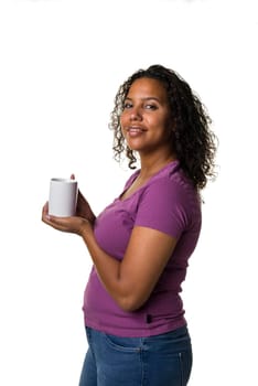 Young mixed race woman in purple shirt drinking a hot liquid from a black and white cup isolated with a white background