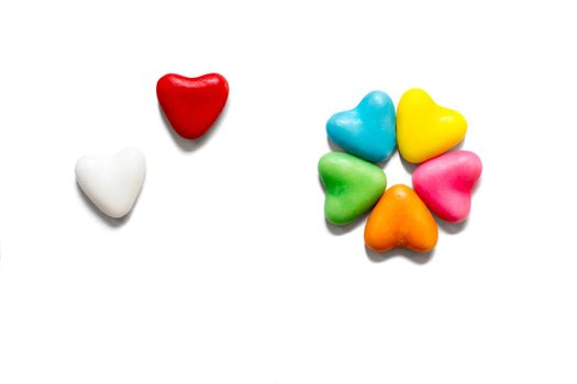 Colorful candy hearts on a white background with copy space