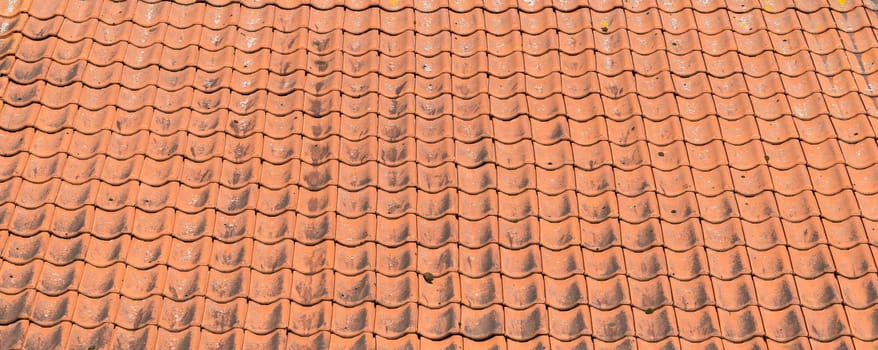 Red roof tiles close up and full frame in rows