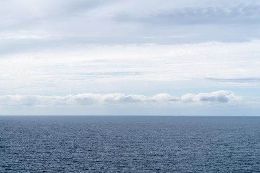 A Blue and white sky with clouds over sea or ocean. Nature composition. Background, landscape