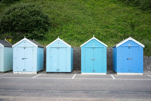 Colorful Beach huts, in blue colors, at the  boulevard in Bournemouth, Dorset, UK, England on cloudy day in summer