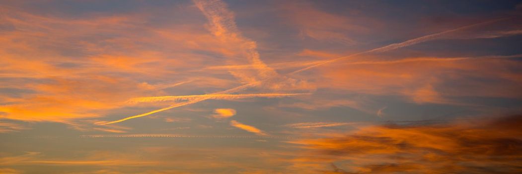 Dramatic red yellow and blue sky at dusk the setting of the evening, a panorama