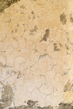 an empty background of cracked creme concrete that is worn down or weathered and showing texture with copy space or space for tekst
