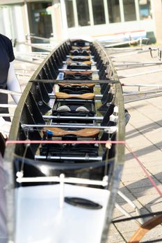 a Look inside a professional carbon fiber rowing boat with seats and sliders and oars top view