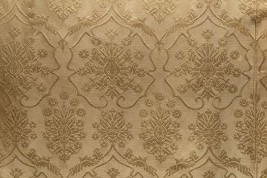 Antique fabric of embroidered silk with circulair and floral patterns and designs