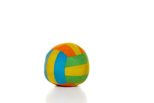 A soft colorful toy ball made of fabric for little children or babies isolated on a white background