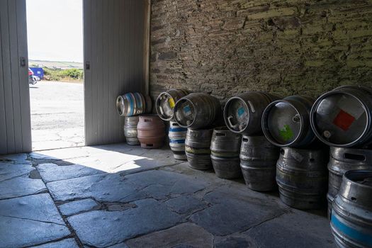 stack or pile of empty beer casks or barrels storage outside a pub