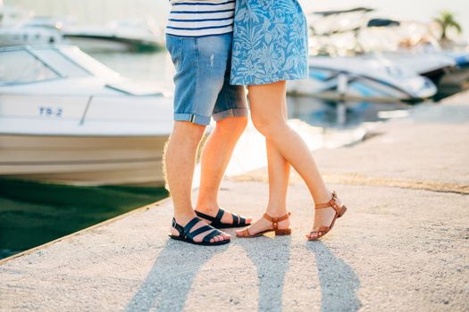 Newlyweds on the quay. Legs close-up. Wedding in Montenegro.