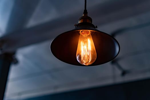 Vintage hanging lamp with light bulb over blurry background