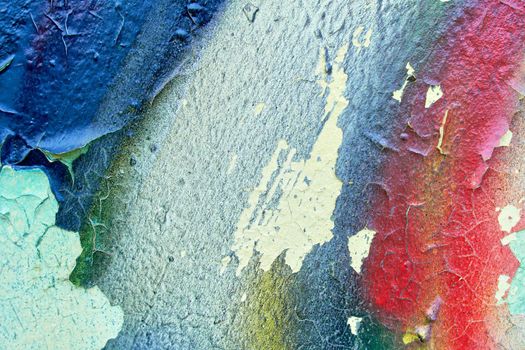 Metallic colorful background with peeling paint and blue stains and rust, texture.