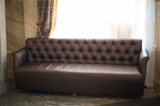 Brown leather sofa in the hall