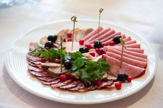 Buffet Dish. Sausage cut decorated with greens