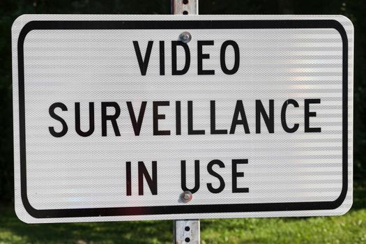 Video surveillance in use - sign on white background