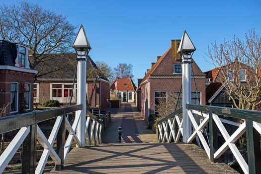 Medieval bridge and houses in the city Hindeloopen in the Netherlands