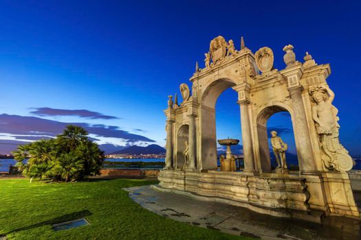Immacolata Fountain in Naples. Vesuvius in the background. Naples, Campania, Italy