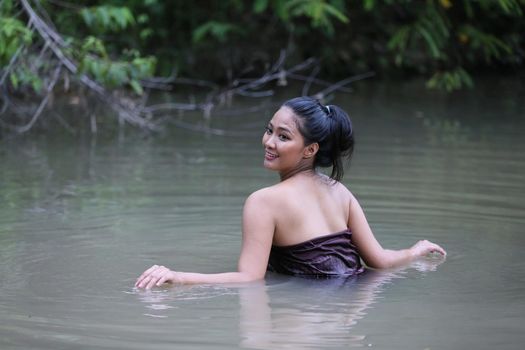 Rural Young Asian Women Bathing In A River, or Portrait Of Beautiful Young Asian Woman Bathing In The River. Asian sexy woman bathing in creek. 