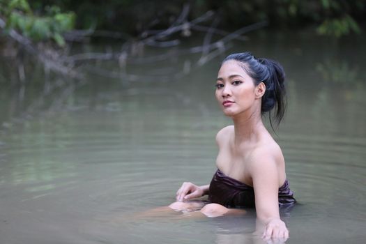 Rural Young Asian Women Bathing In A River, or Portrait Of Beautiful Young Asian Woman Bathing In The River. Asian sexy woman bathing in creek. 