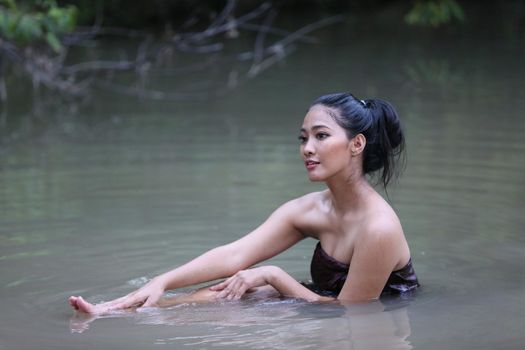 Rural Young Asian Women Bathing In A River, or Portrait Of Beautiful Young Asian Woman Bathing In The River. Asian sexy woman bathing in creek. 