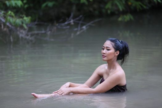 Rural Young Asian Women Bathing In A River, or Portrait Of Beautiful Young Asian Woman Bathing In The River. Asian sexy woman bathing in creek. 