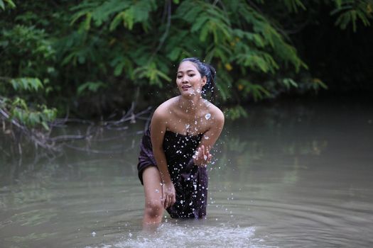 Rural Young Asian Women Bathing In A River, or Portrait Of Beautiful Young Asian Woman Bathing In The River. Asian sexy woman bathing in creek. 