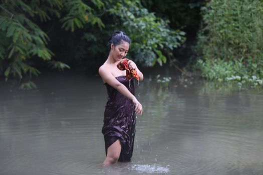 Rural Young Asian Women Bathing In A River, or Portrait Of Beautiful Young Asian Woman Bathing In The River. Asian sexy woman bathing in creek. 