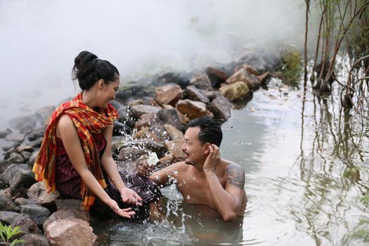 Thailand Couple love enjoy in bathing together in the river against rural background. this is life of young man and young girl couple in Countryside Thai South East Asia.