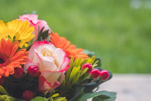 Close up of tender pink rose in a floral bouquet