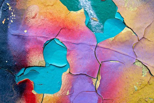 Metallic colorful background with peeling paint and bright spots and rust, texture.