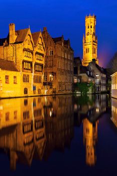 Belfry of Bruges reflected in the canal. Bruges, Flemish Region, Belgium