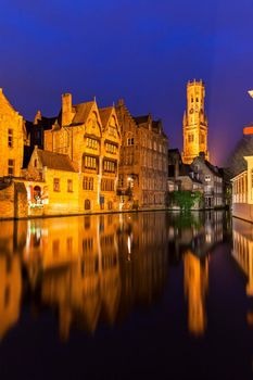 Belfry of Bruges reflected in the canal. Bruges, Flemish Region, Belgium