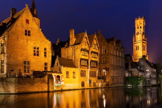 Belfry of Bruges reflected in the canal. Bruges, Flemish Region, Belgium